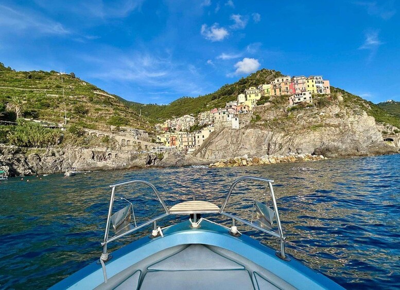 A boat's view of a coastal village with colorful buildings on a hillside. 4