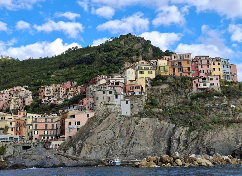 A coastal village with colorful buildings perched on a hillside. 2