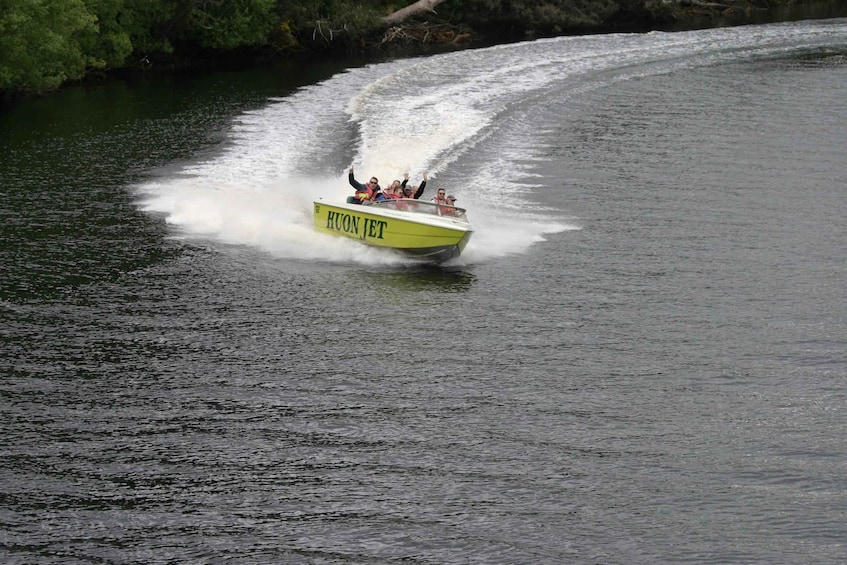 A speedboat with passengers, creating a wake in the water. 3