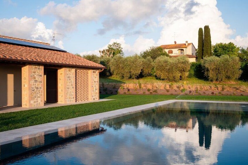 A swimming pool, a stone building, and a house with a tiled roof. 2