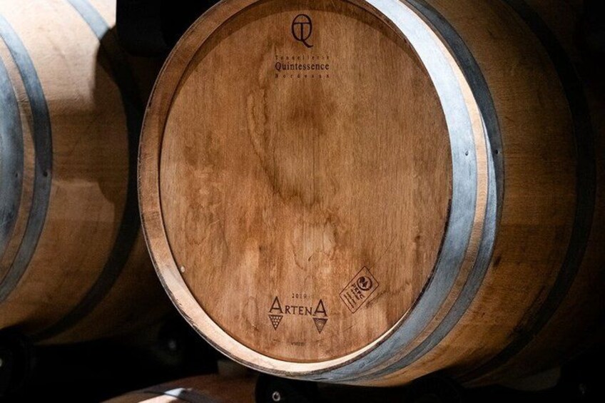 A wooden barrel with the text 'Quintessence' and '2016' visible. 5