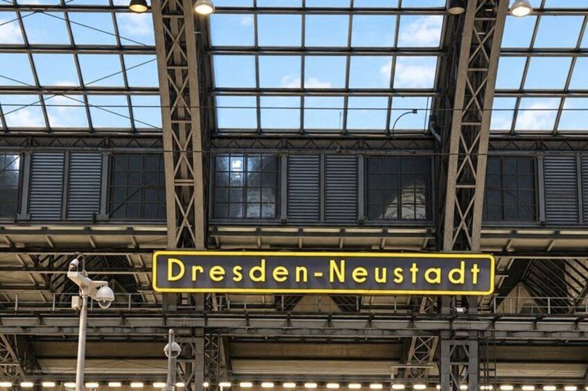 A train station with a sign reading 'Dresden-Neustadt'. 3