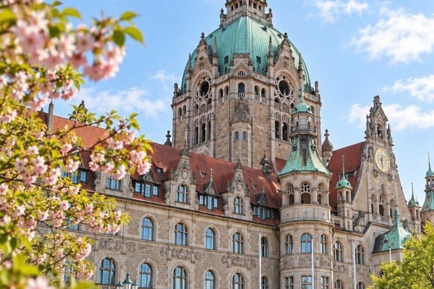 A historic building with ornate architecture, including a prominent dome and clock tower. 3
