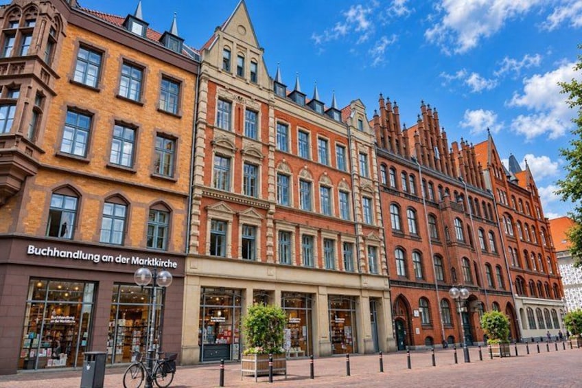 A street with historic buildings, a bookstore, and a bicycle. 2
