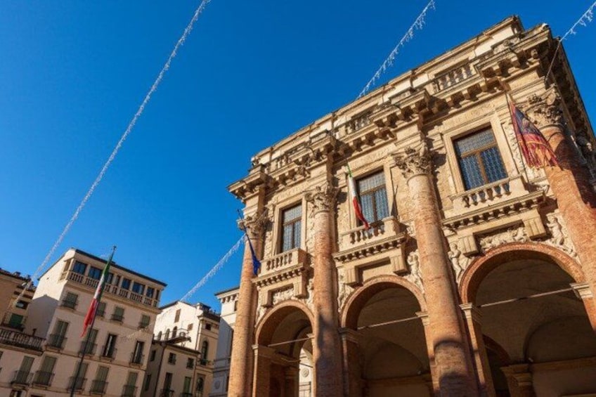 A historic building with classical architecture, featuring columns, arches, and detailed stonework. 3