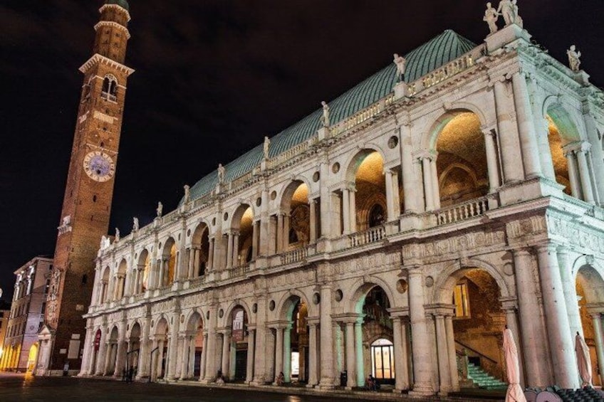A historic building with a clock tower and arched windows. 5