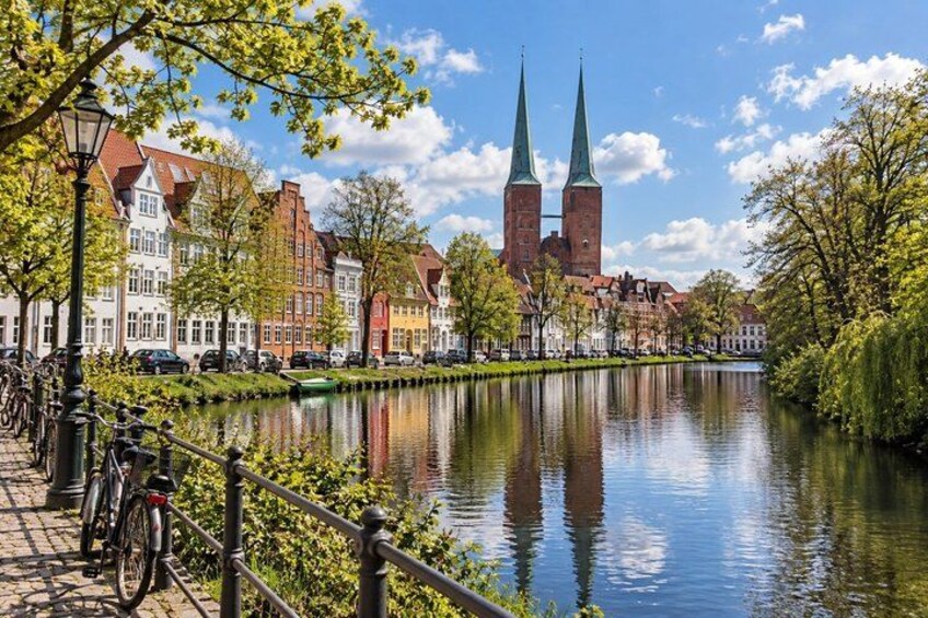 A canal with a church and buildings along the water. 5
