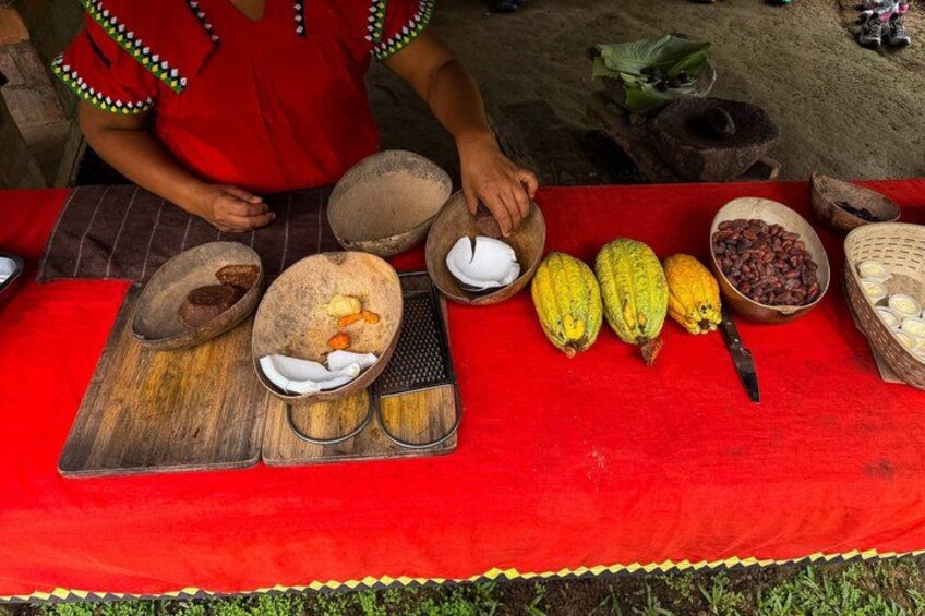 A person preparing food with various ingredients on a red tablecloth. 5