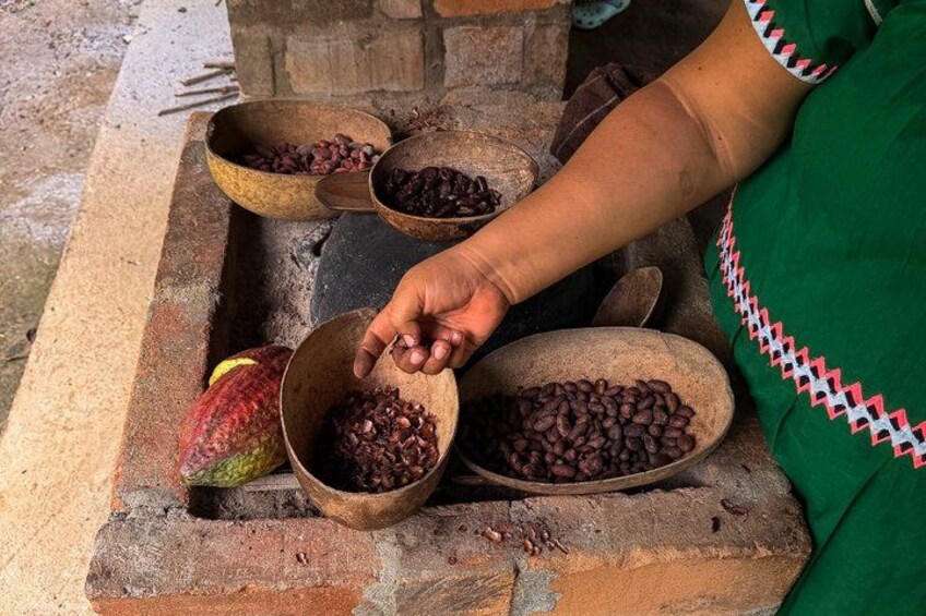 A person sorting beans in wooden bowls at a market. 4