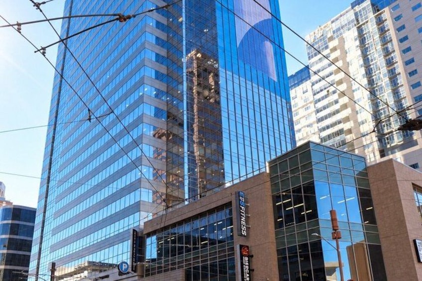 A modern glass building with a visible sign for 'BISSELL' and a tram line overhead. 4