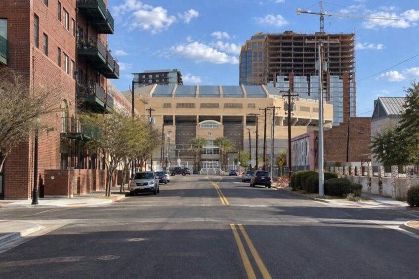 A street with buildings, a clear sky, and a construction site in the background. 5