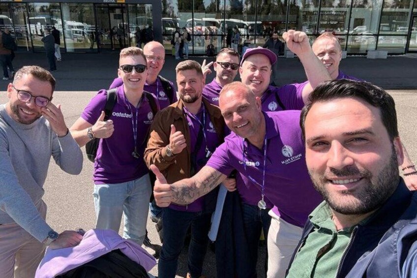 A group of people in purple shirts posing for a photo. 4