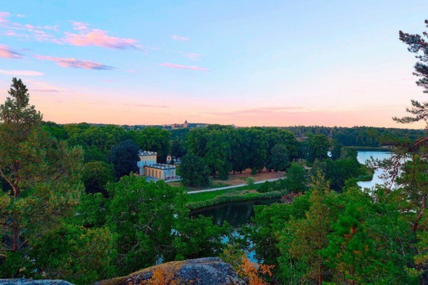 A landscape with a large building surrounded by trees and a river. 2