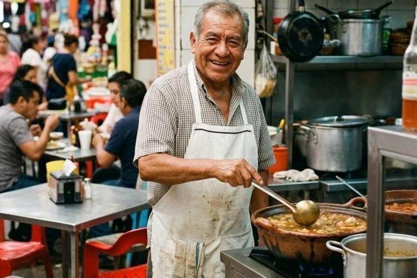 A person cooking in a busy kitchen with pots and pans. 4