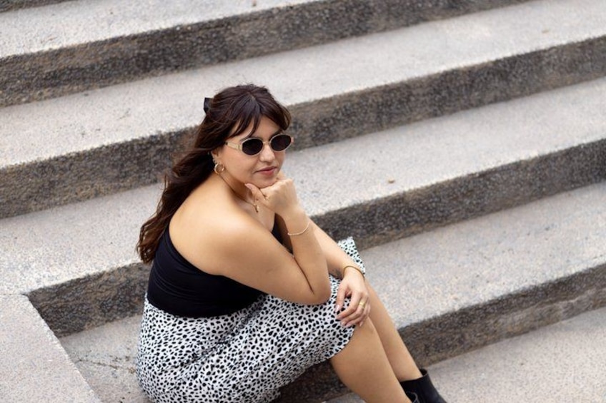 A person sitting on stone steps. 2