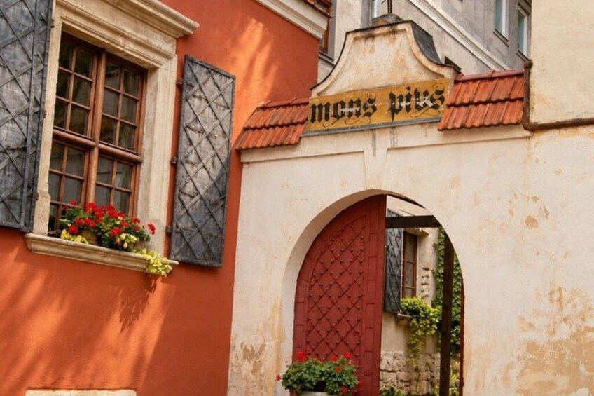 A building with a red door and a sign above it. 4