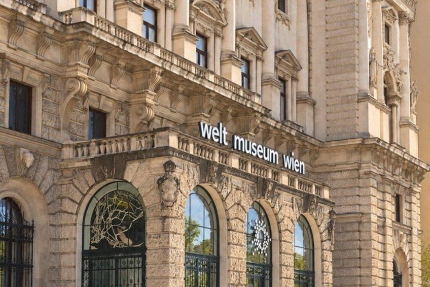 The exterior of the Welt Museum Wien with ornate stone architecture and arched windows. 5