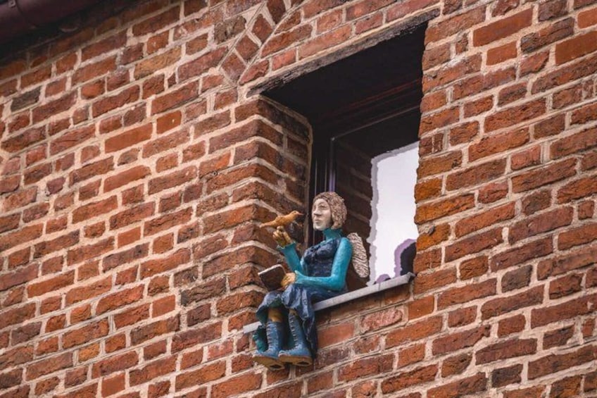 A brick wall with a small window. 5