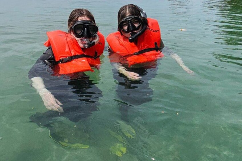 Two people snorkeling in clear water. 3