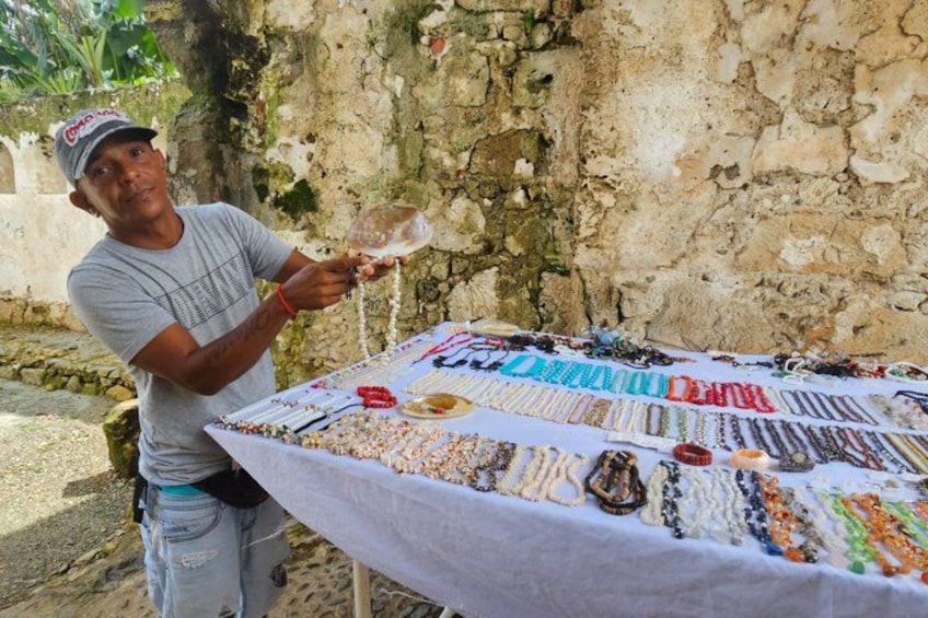 A person selling jewelry at an outdoor market. 5