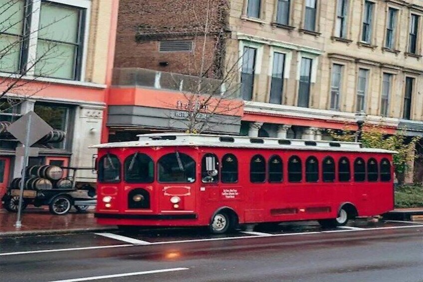 A red trolley on a city street. 2