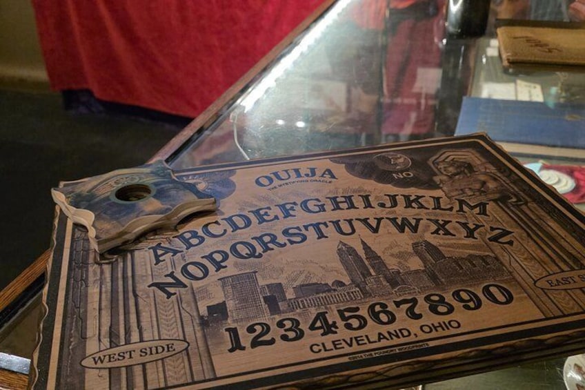 A wooden board with a city skyline and a number '1234567890' on it. 1