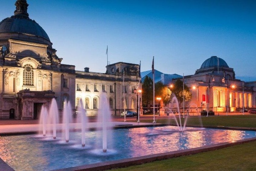 A classical building with a dome and fountain in front. 2