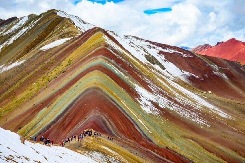 A colorful mountain with a group of people hiking. 4