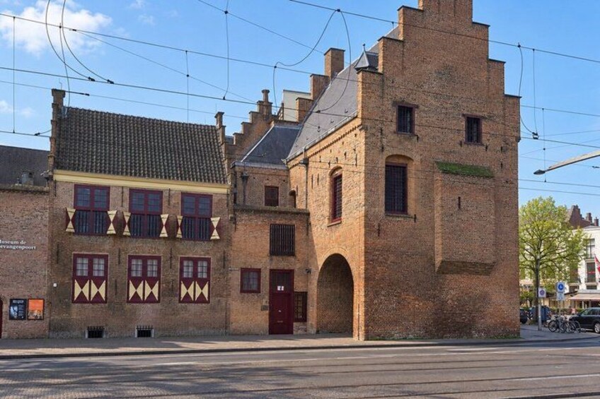 A historic building with a red door and a brick tower. 5
