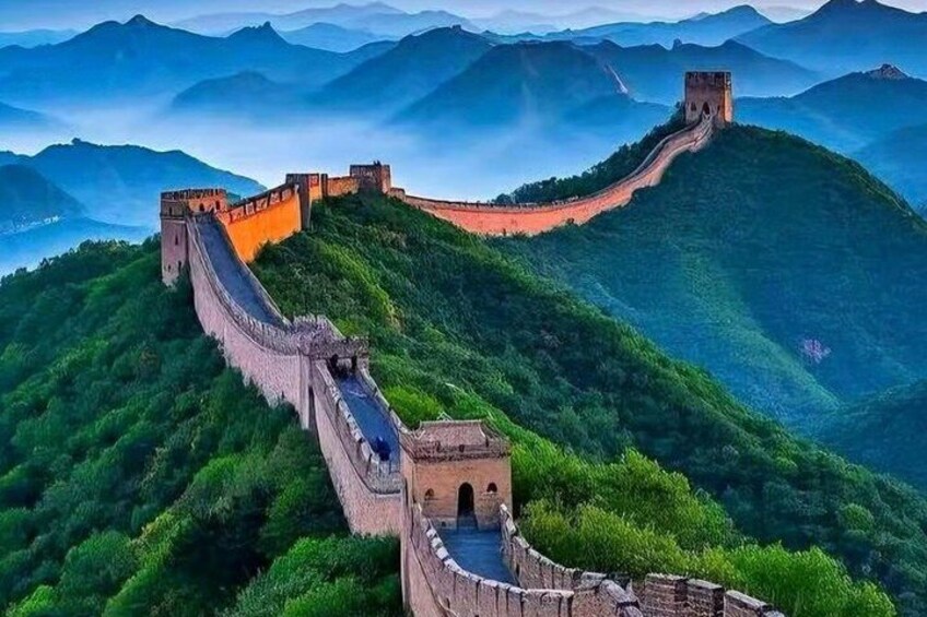 The Great Wall of China winding through lush green hills. 1