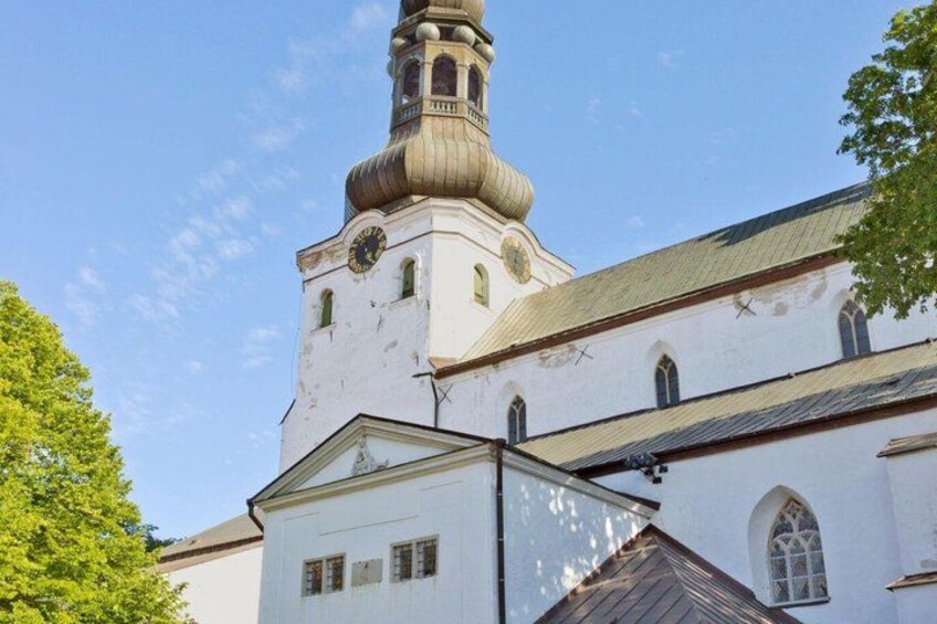 A church with a prominent bell tower and a steeple. 4