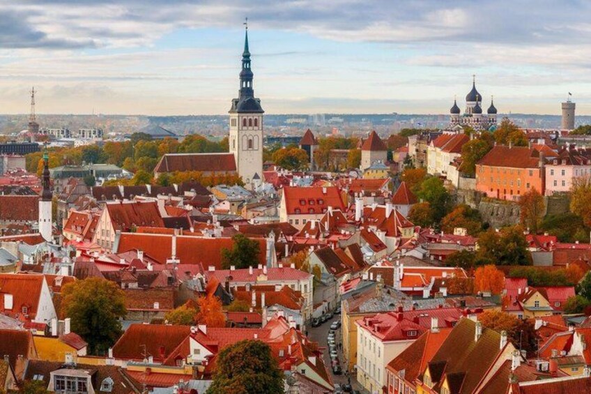 A cityscape with historic buildings, a prominent tower, and domed structures. 1