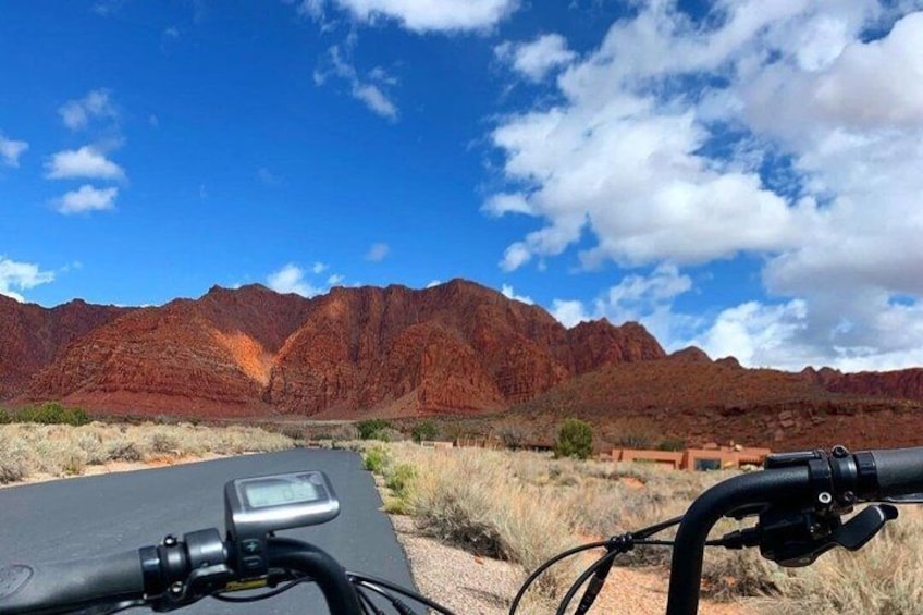 A desert landscape with red rock formations and a clear sky. 3