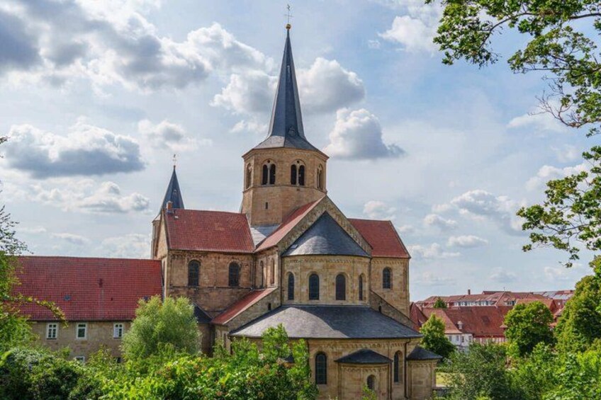 A historic church with a prominent tower and a red-tiled roof. 2