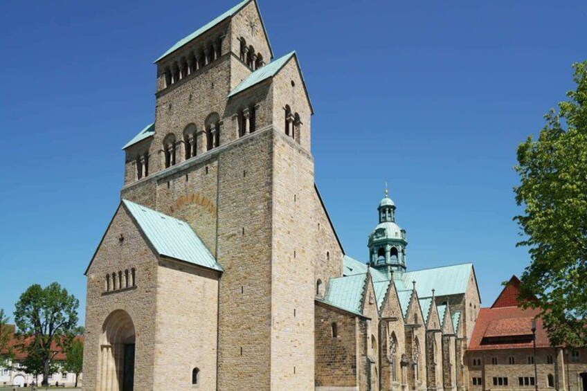 A historic church with a tall bell tower and a smaller spire. 5