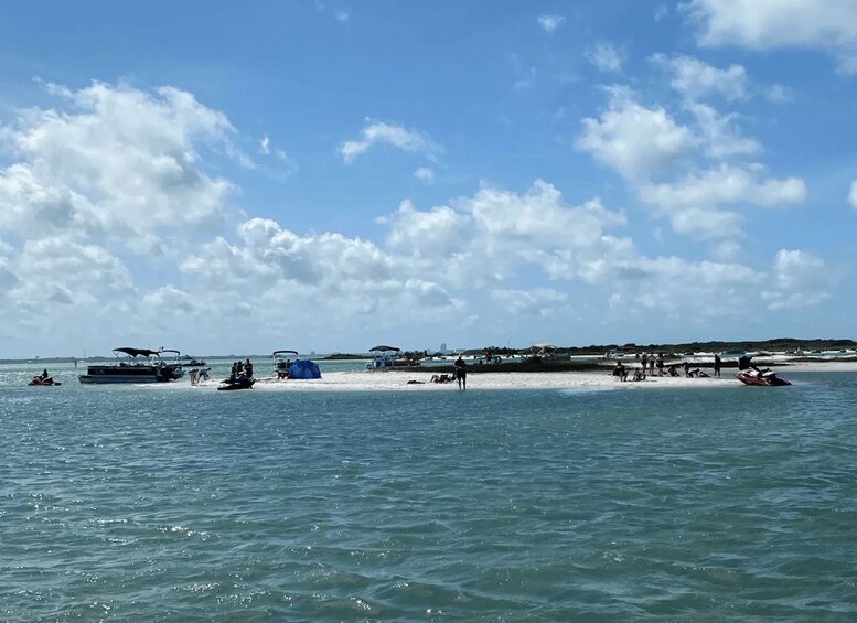 A beach with boats and people. 2