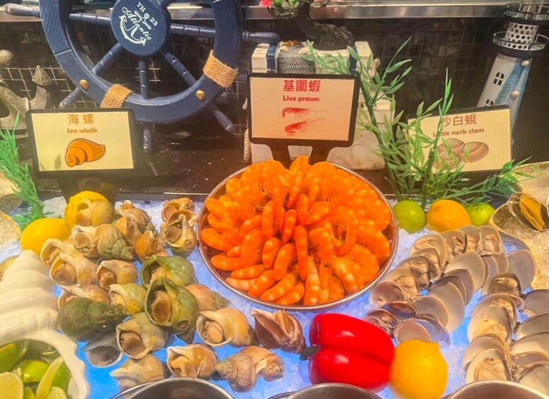 A seafood display with live prawns, sea urchins, and clams. 4