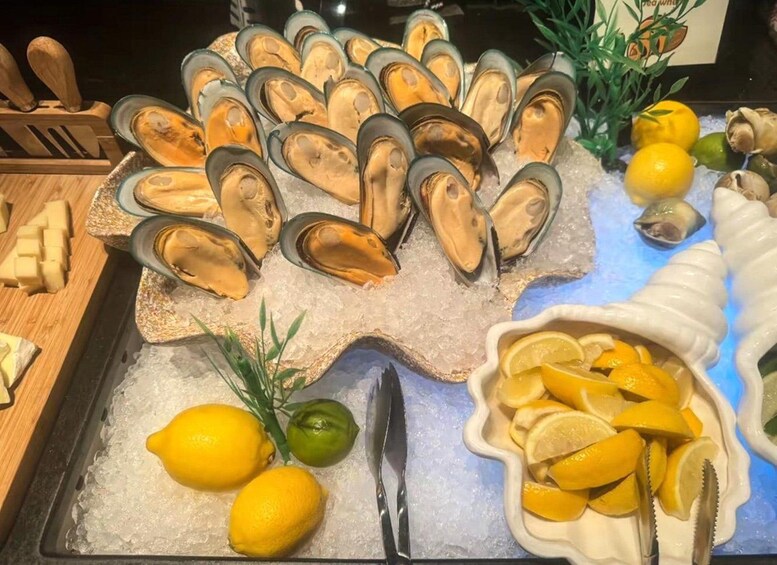 A display of mussels on ice, lemons, and a knife. 5