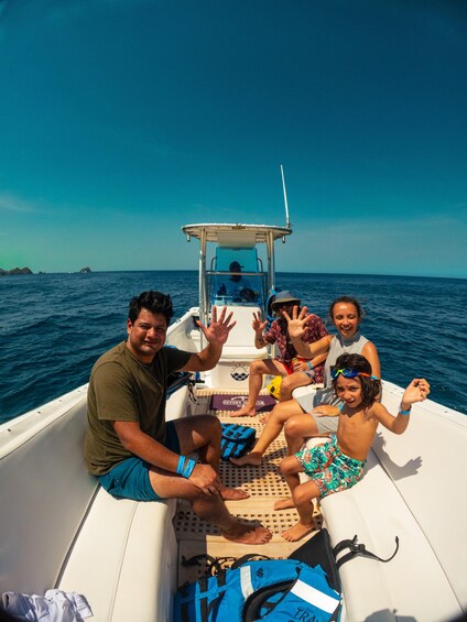 A family on a boat with a clear blue sky and calm sea. 5