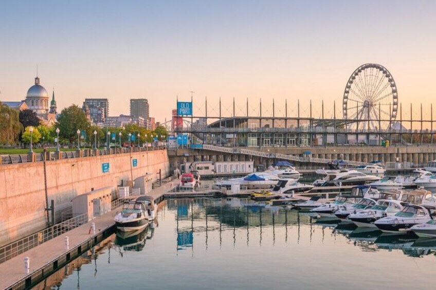 A marina with boats docked, a Ferris wheel, and a domed building in the background. 4