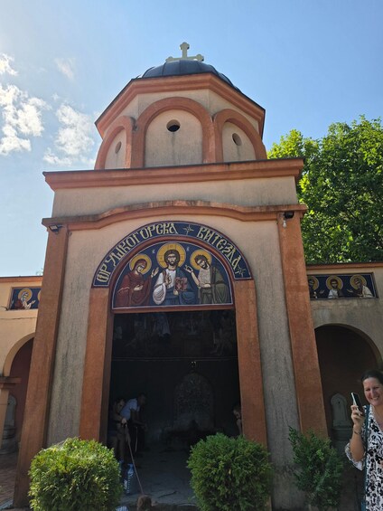 A church entrance with a dome and a cross on top. 2