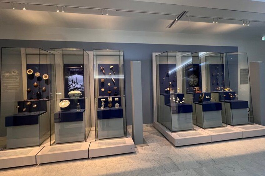 A museum exhibit with glass display cases containing various artifacts. 5