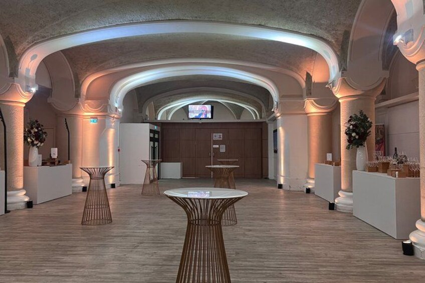 A spacious interior with a high ceiling, wooden flooring, and modern furniture. 2