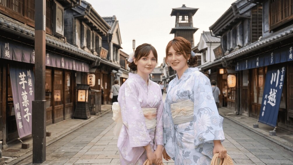Two people in traditional Japanese attire walking down a street lined with buildings. 1