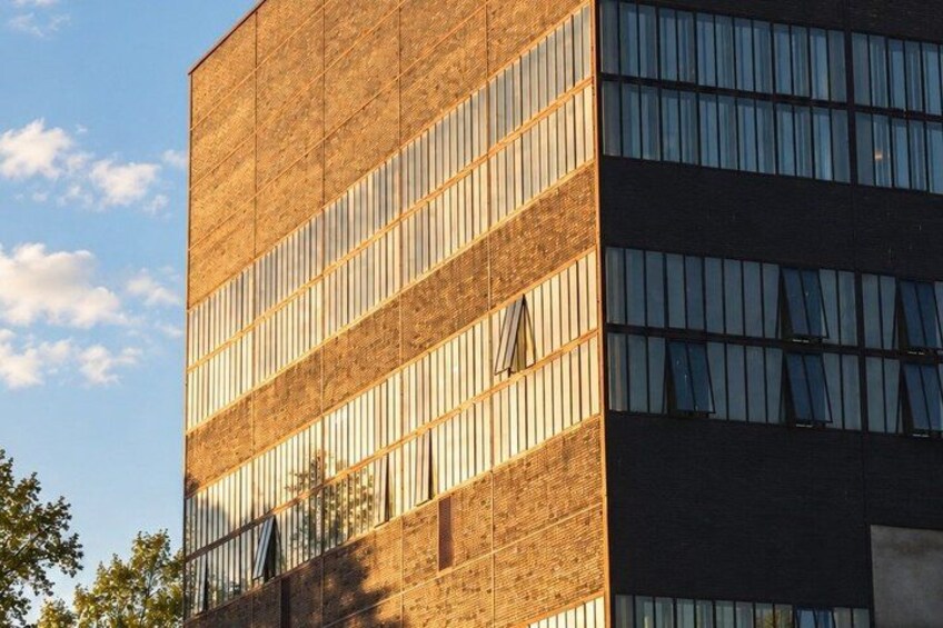 A modern building with a brick facade and large windows. 5