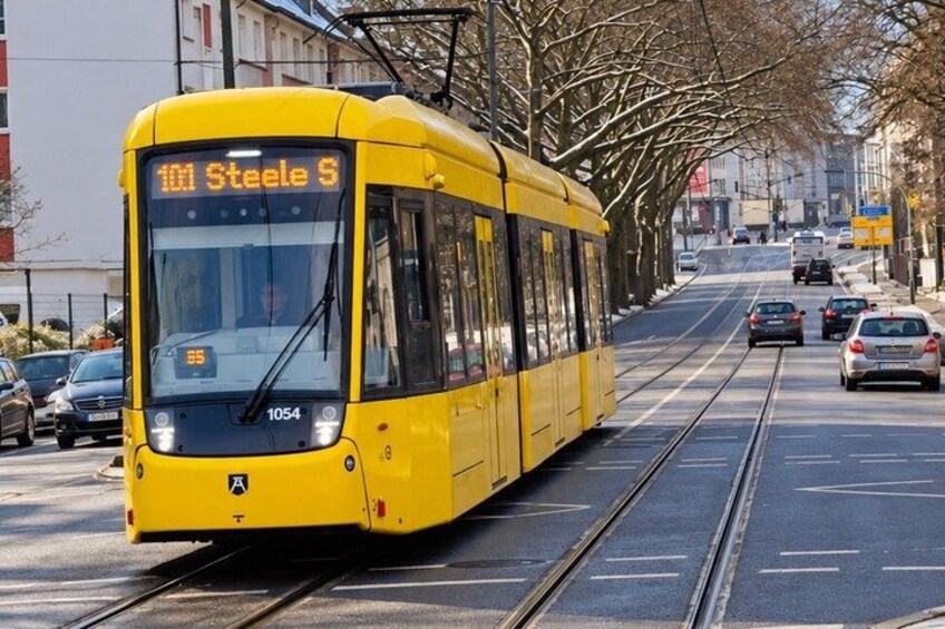 A yellow tram with the number 101 and destination 'Steele S' on a city street. 3