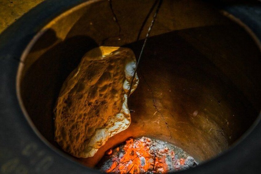 A bread loaf in a pot with glowing embers. 5