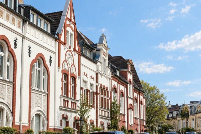 A historic building with ornate architecture, including arched windows and a clock tower. 5