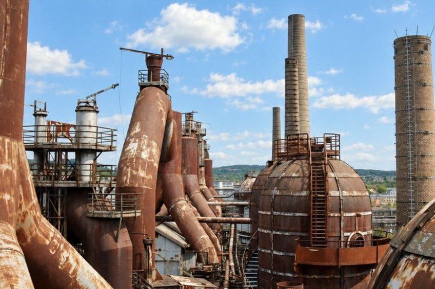 Industrial structures with large pipes and a dome-shaped building. 3