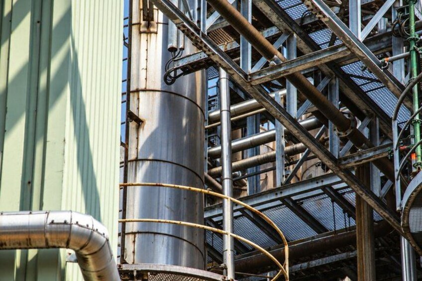Industrial metal structures, pipes, and a cylindrical tank. 2